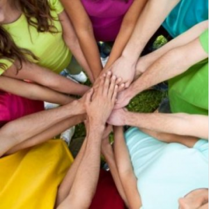 A circle of arms clasping hands in the middle to show cooperation gaining ground in evolutionary theory