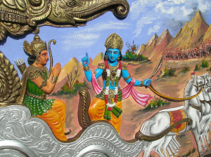Colorful relief of Krishna with blue skin instructing Arjuna in a chariot.
