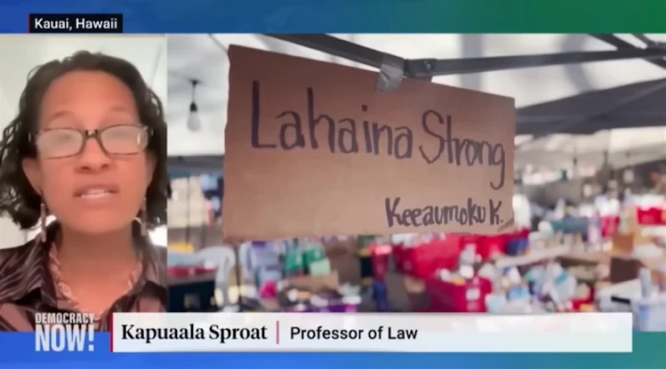 Kapuaʻala Sproat speaking on Democracy Now next to an image of relief supplies under a big sign that says "Lahaina Strong"