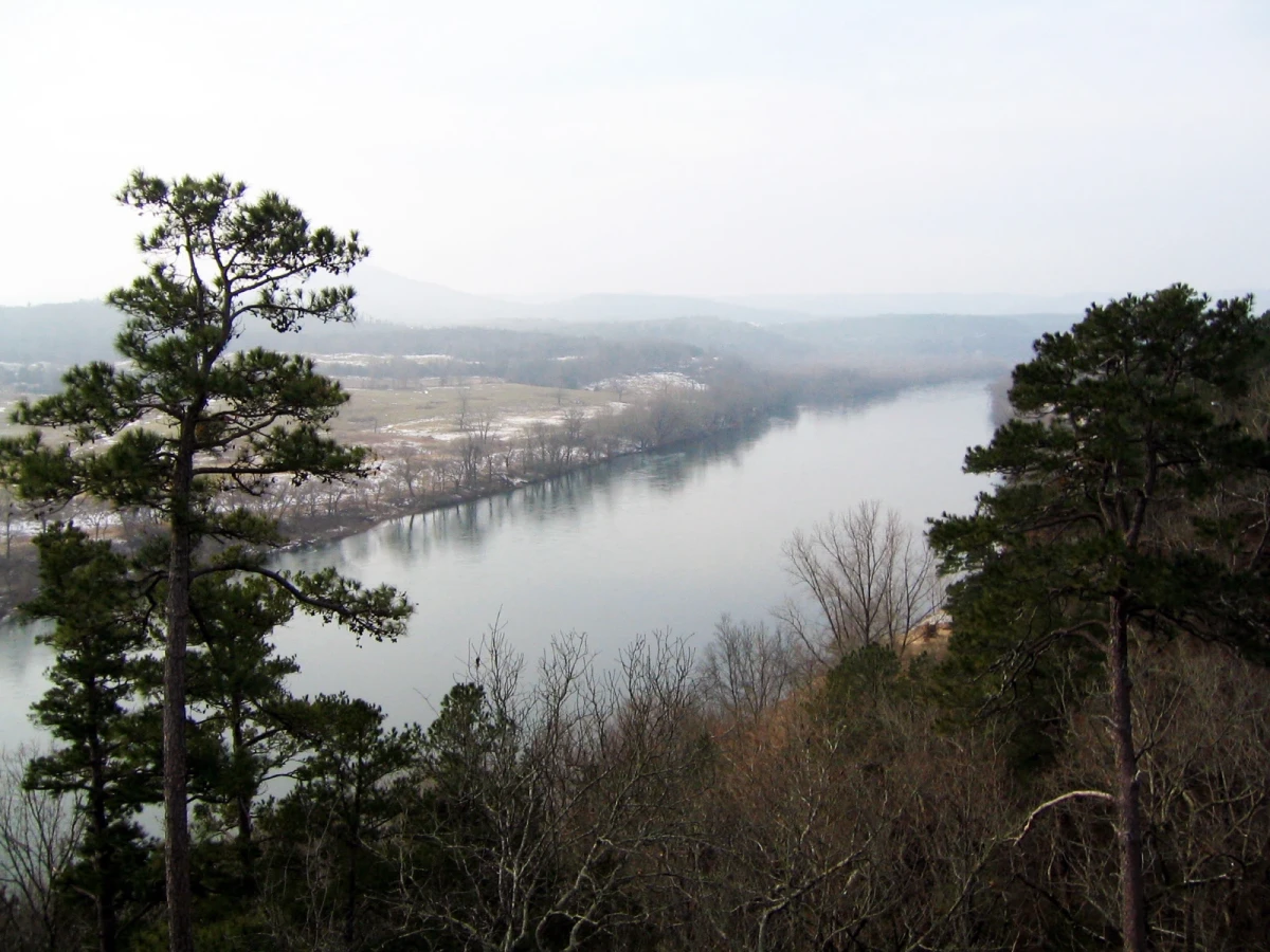 Looking down on a wide and still river in hazy winter light